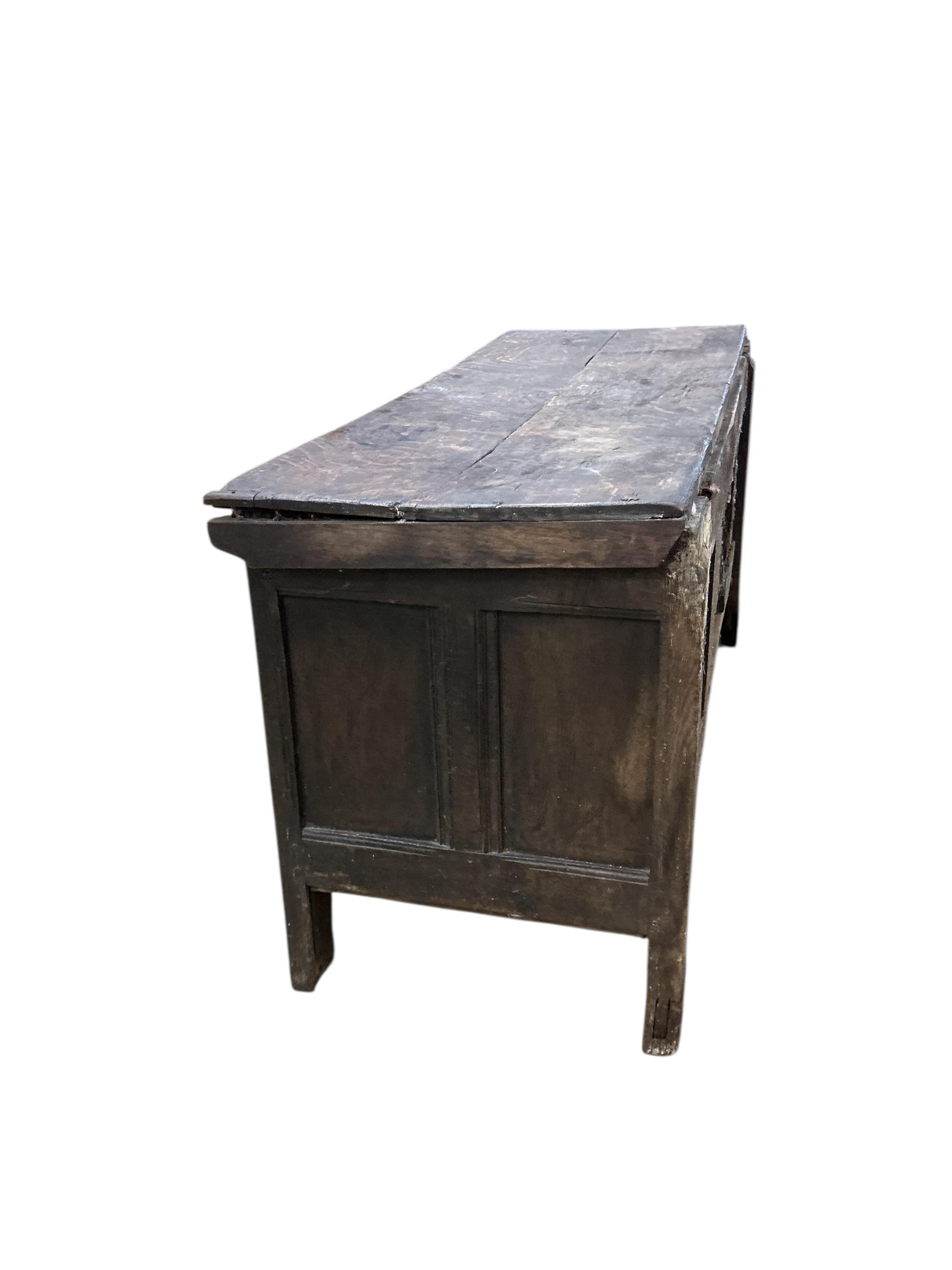 An 18th century panelled oak coffer, width 144cm, depth 54cm, height 72cm